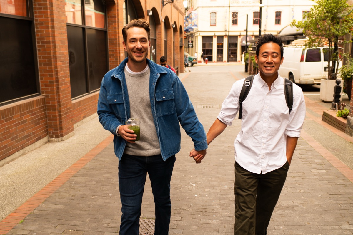 Two members walking down a brick lane in Victoria